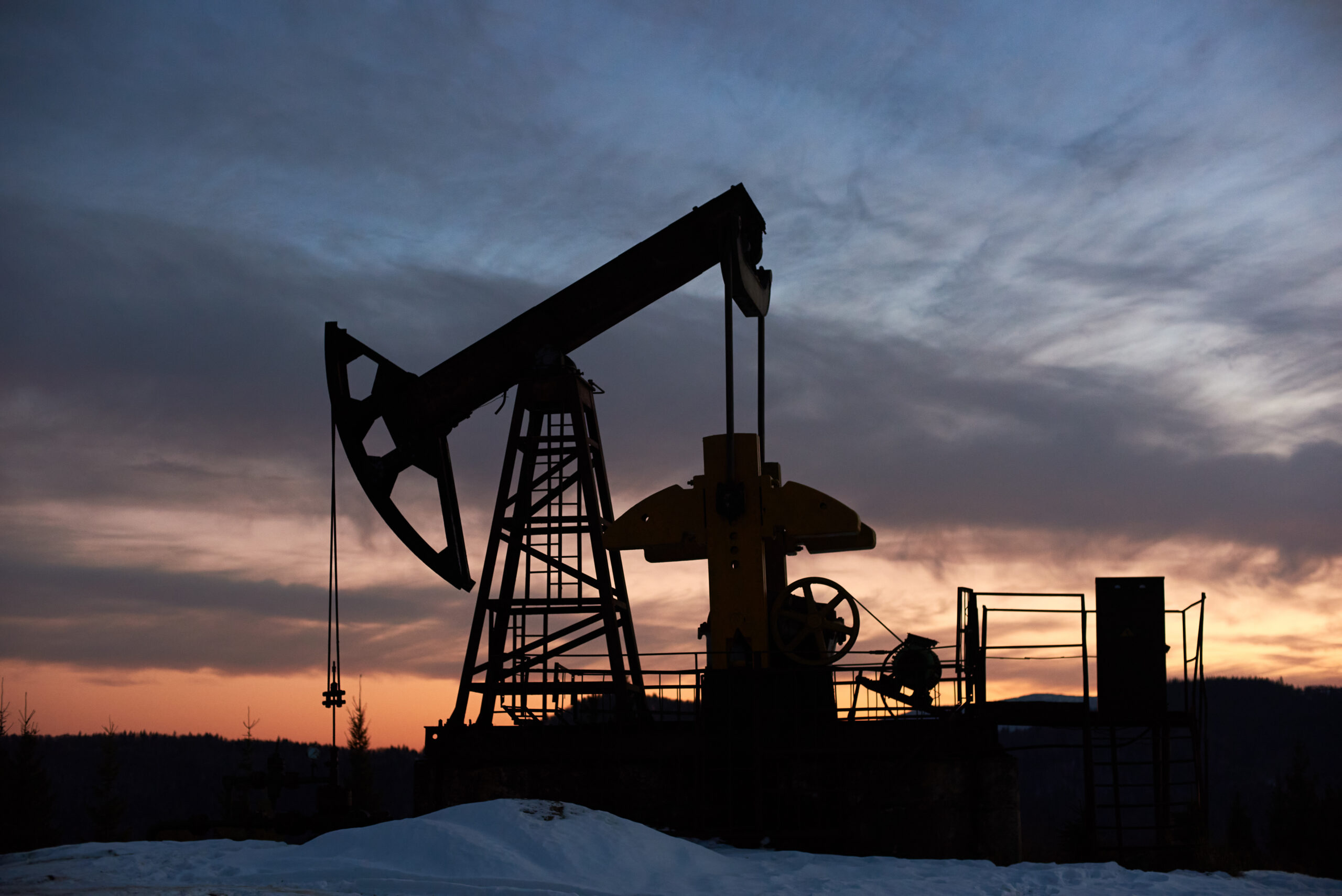 Oil field pump jack at sunset