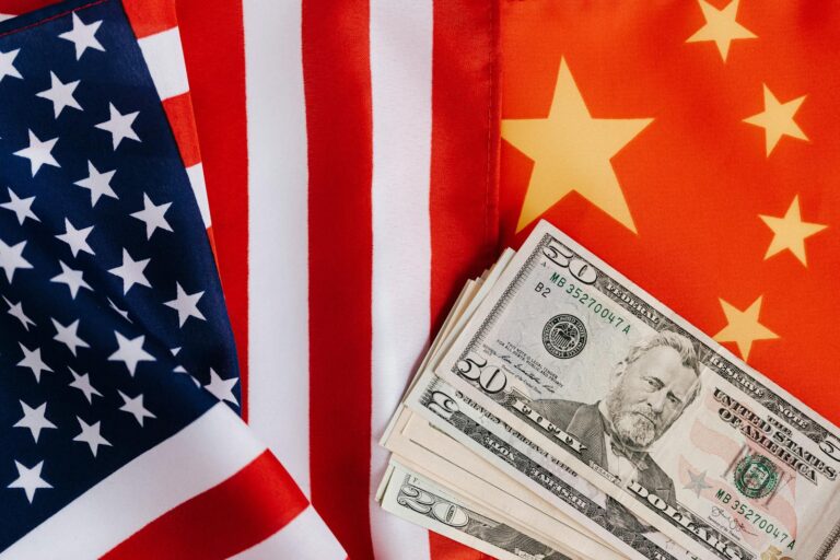 American and Chinese flags arranged alongside US dollar banknotes