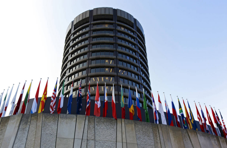 The Bank for International Settlements tower in Basel, Switzerland, with a row of national flags in front