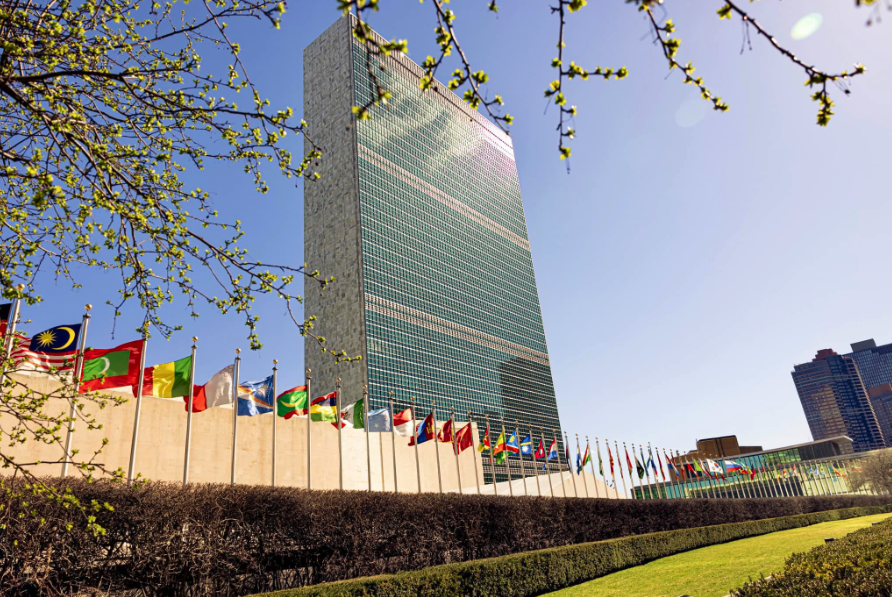United Nations Headquarters, New York, USA: the Secretariat tower behind the line of member state flags
