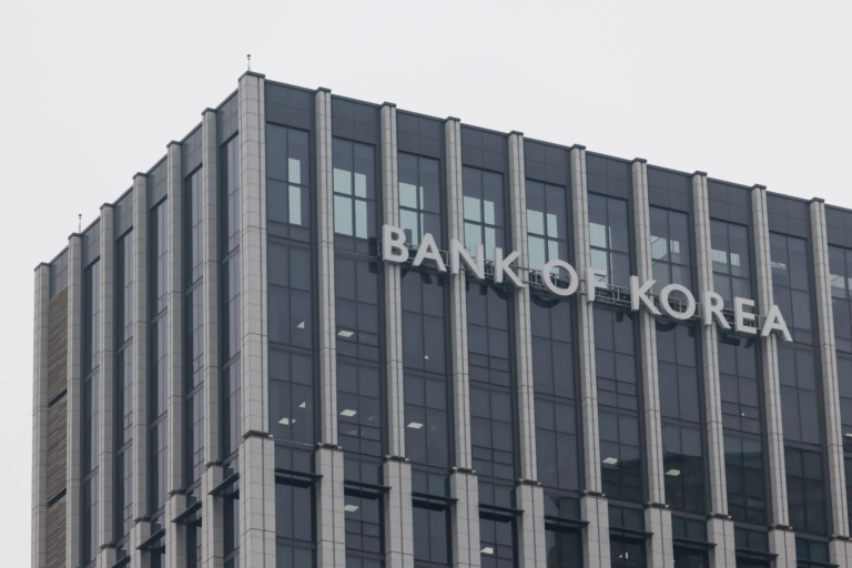 The words BANK OF KOREA in silver letters on the upper facade of a glass and stone office building