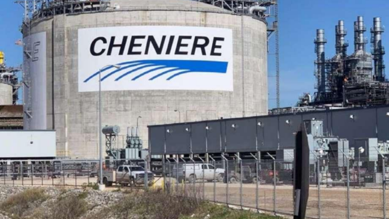 A large LNG storage tank painted with the Cheniere logo, beside processing units and a fenced compound