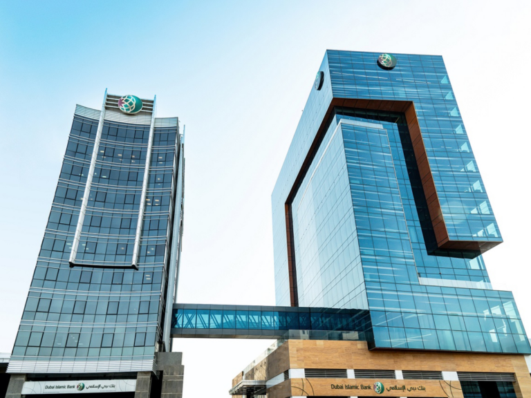 The two glass towers of the Dubai Islamic Bank head office, joined by a skybridge, with the bank's logo on the rooftops and its name on the building fronts