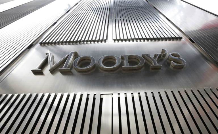 The Moody's name in raised silver letters on a brushed steel facade, between rows of vertical metal fins, seen from below