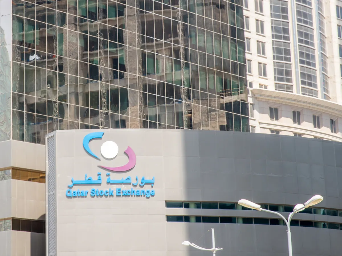 The Qatar Stock Exchange logo and its Arabic and English names on the facade of its building
